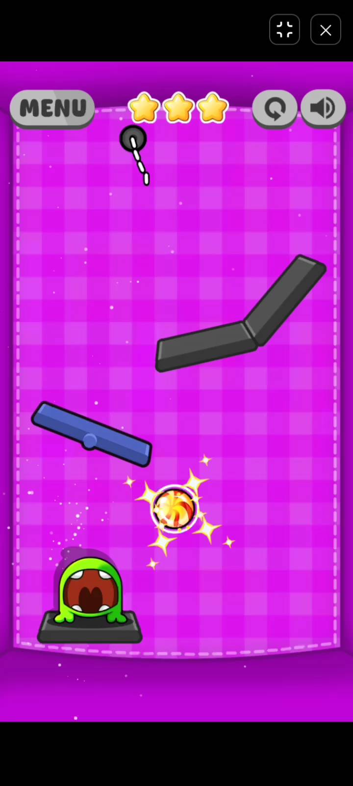 A more challenging level layout in Candy Cutter Saga Kids with multiple ropes and obstacle pathways